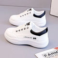 Women's white Korean-style casual shoes with cross strap detail and a synthetic leather upper.