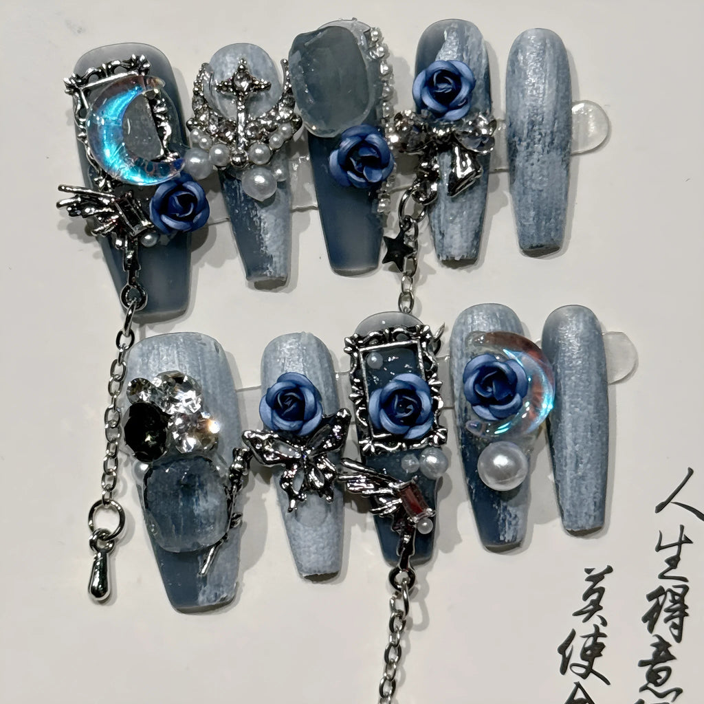 Heavy industry blue manicure nails with rose and tulip floral patterns in plastic armour suit packaging