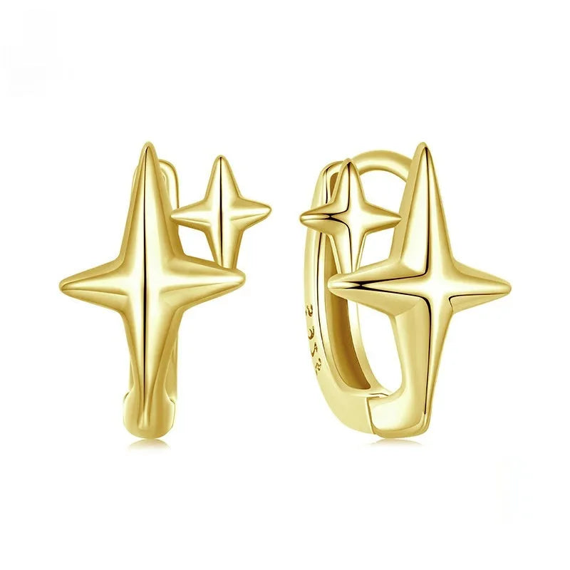 Sterling silver ear clips with minimalist star design and oxidation finish.