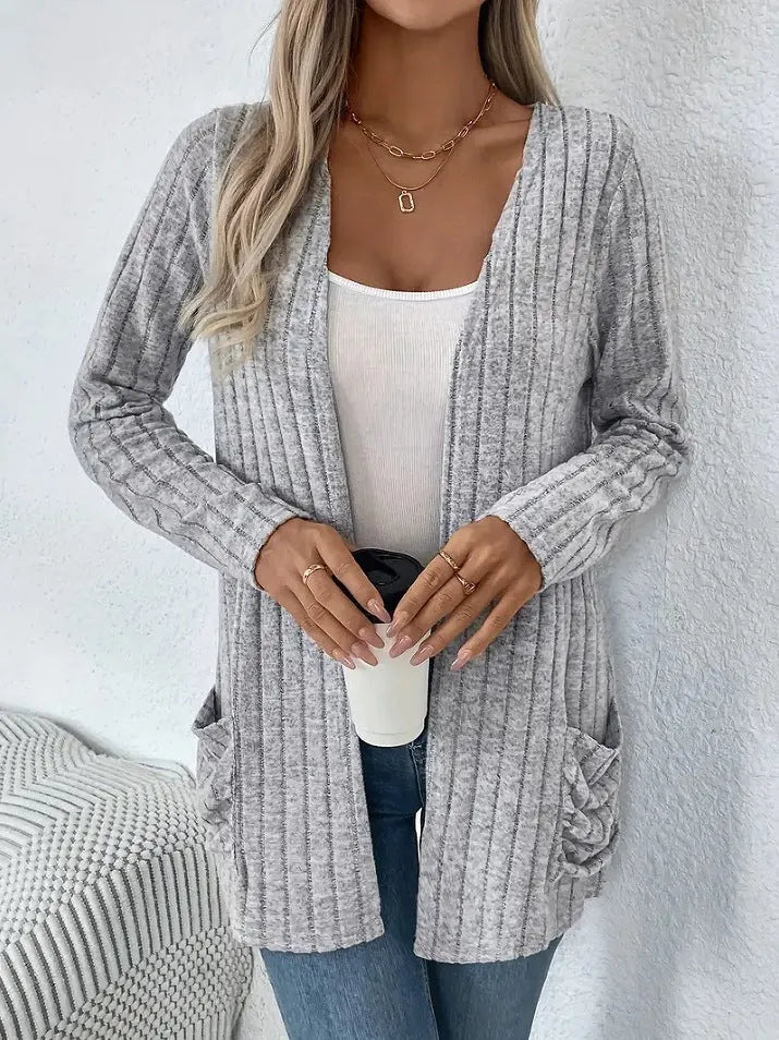 A woman's loose-fit long sleeve cardigan in Grandad Grey with pockets, shown on a hanger.
