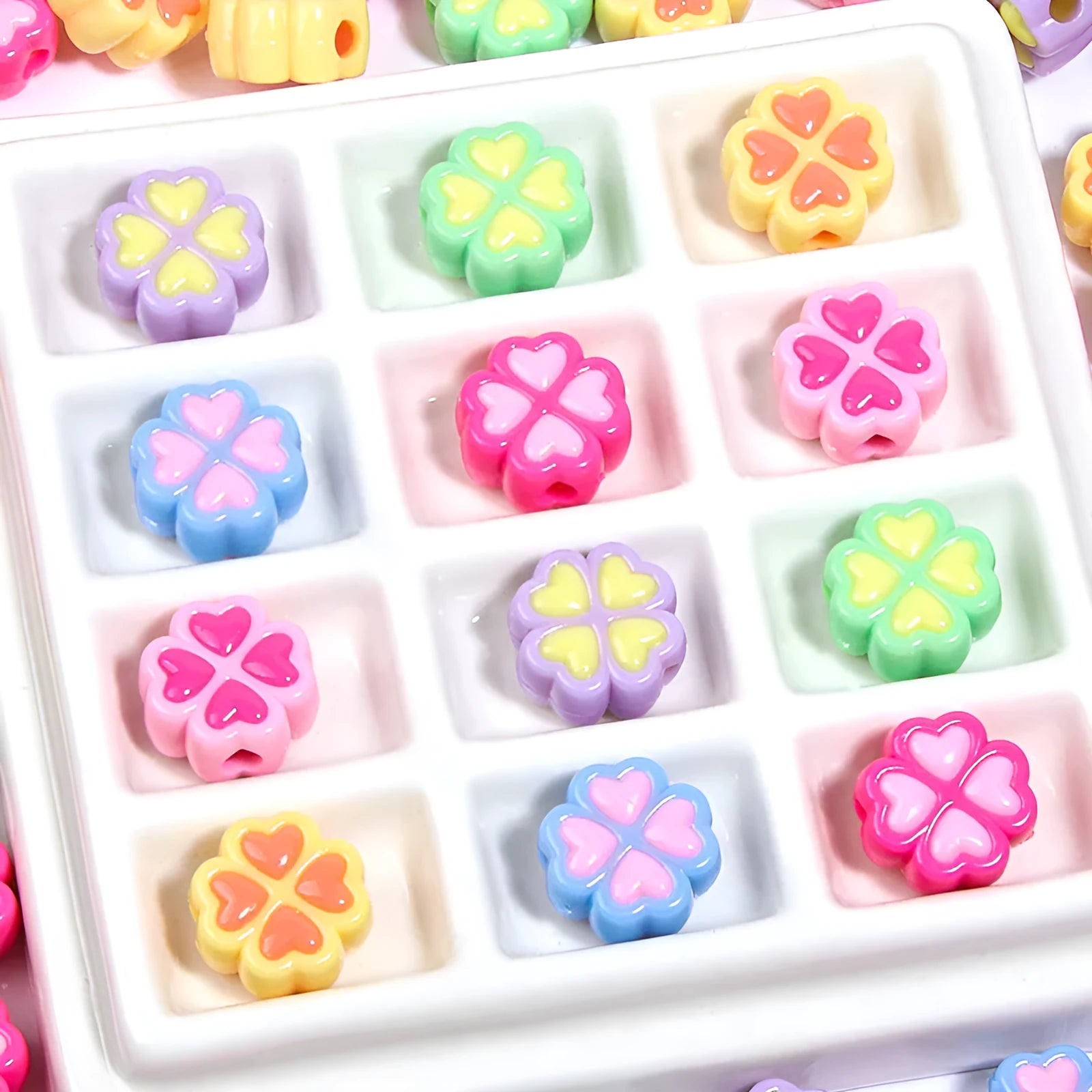 Assorted light-coloured acrylic clover-shaped beads with frosted finish, 15mm size.