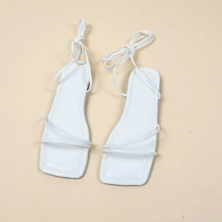 Women's flat sandals with ankle bandage cloth detail and front lace-up fastening