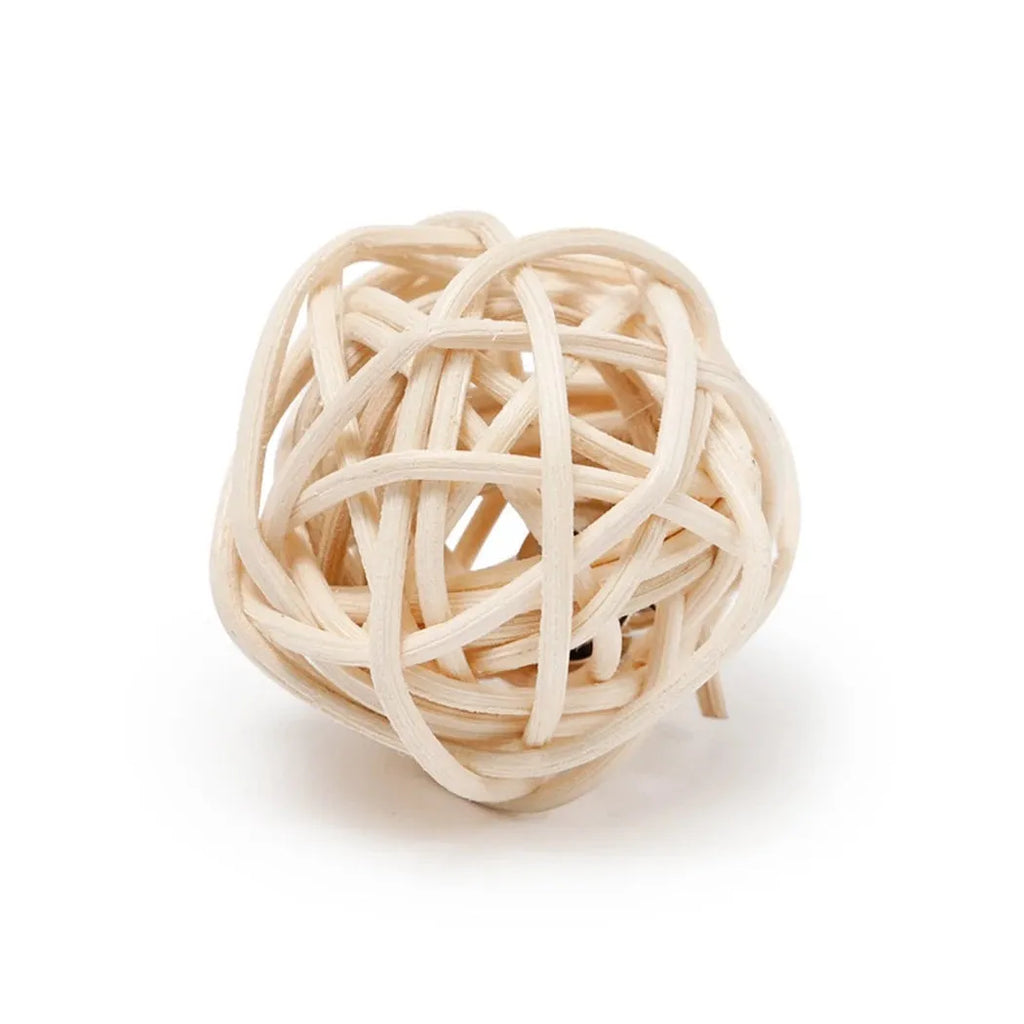 Two cat toy balls: one rattan sphere and one colourful faux feather ball with bell on a neutral background