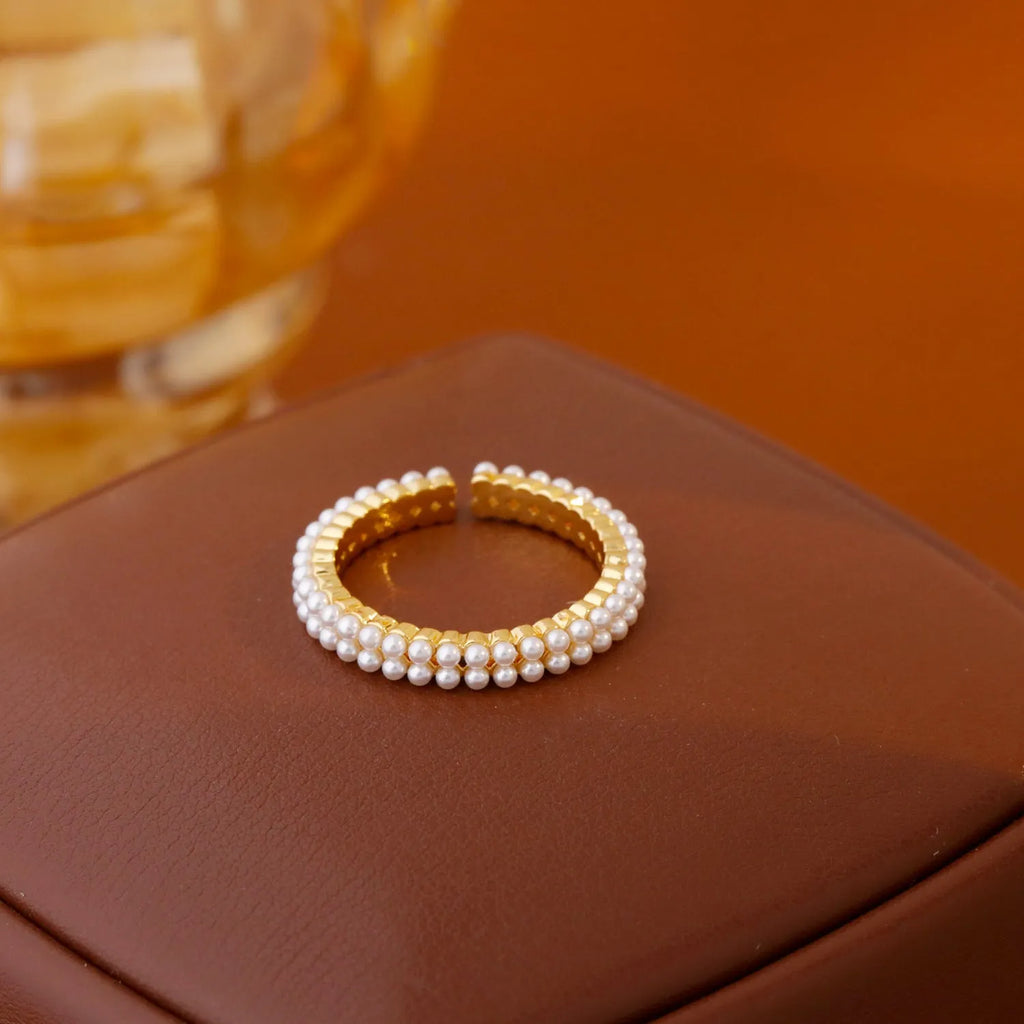 Gold geometry ring with open mouth design and round elements on copper
