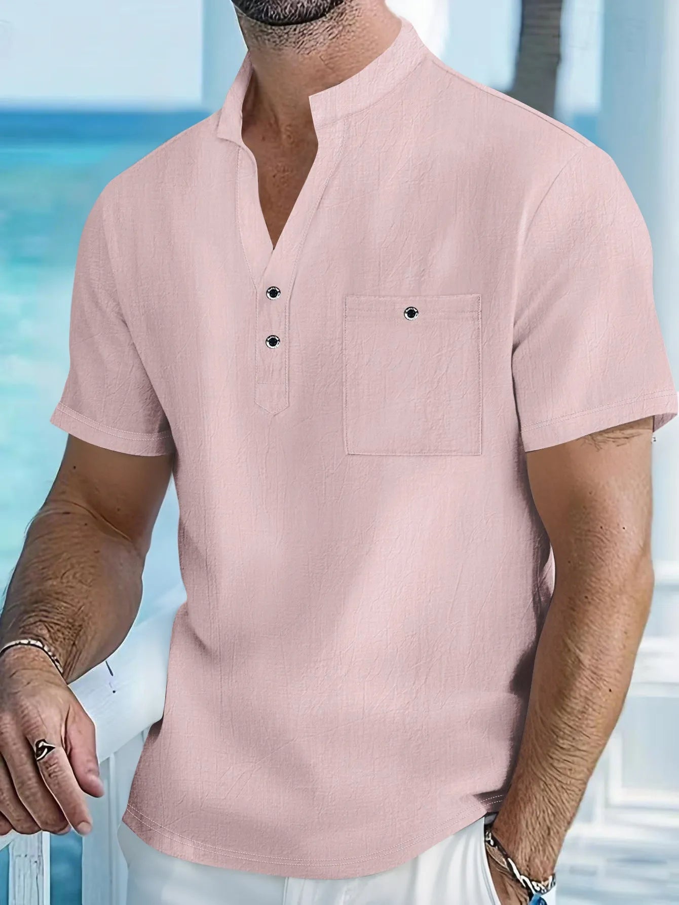 Man wearing a light apricot-coloured linen stand collar T-shirt with short sleeves and a loose fit.
