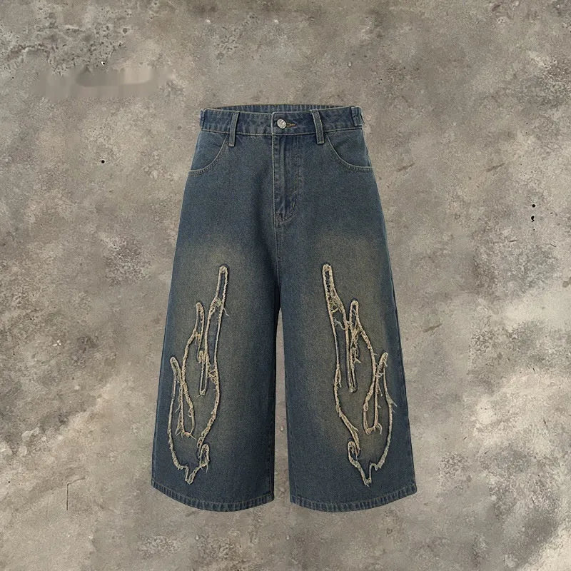 Men's black denim shorts with red flame embroidery patches on legs