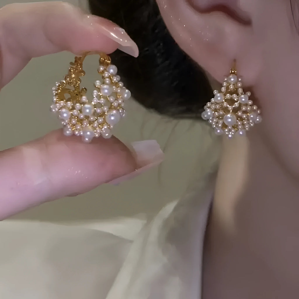 Gold-coloured copper wire flower basket earrings with small beads and inlaid pearls