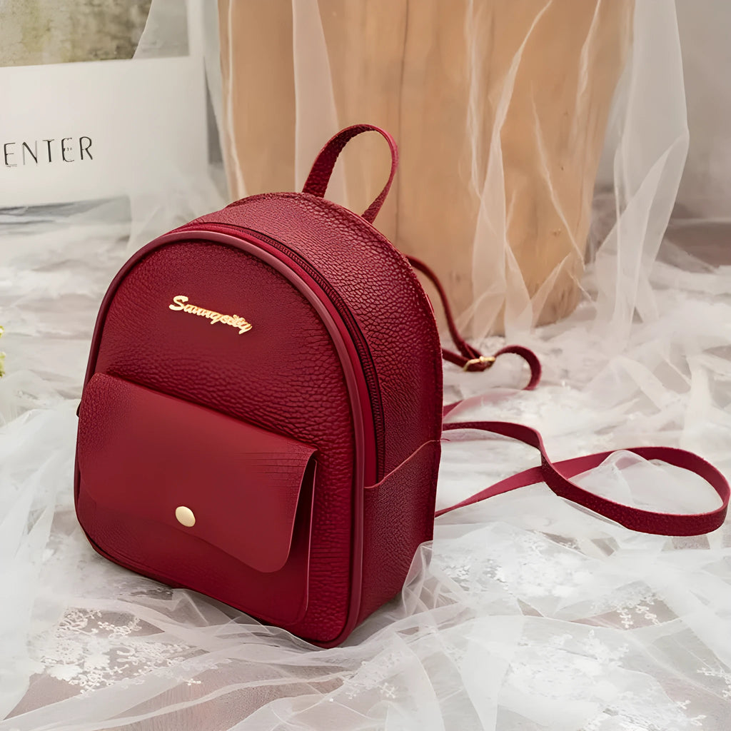 Women's small PU backpack shoulder bag in black, blue, grey, pink, or red with zipper closure