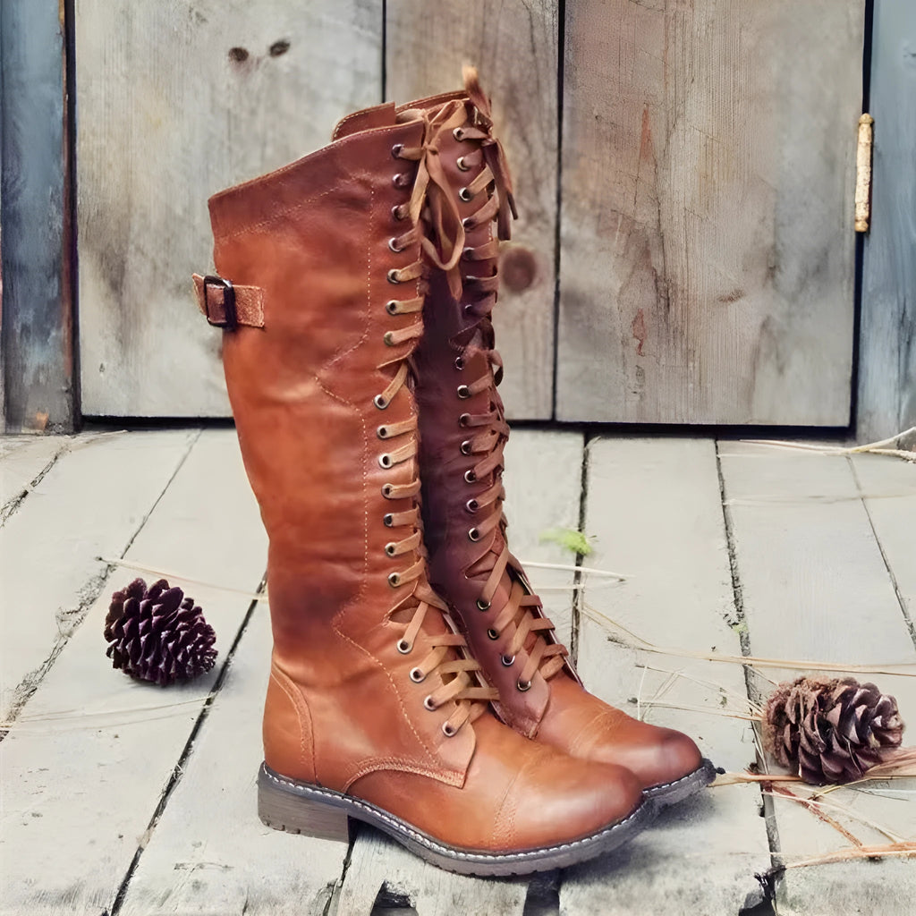 Women's black chunky heel high-leg ankle boots with a round toe on a plain background.