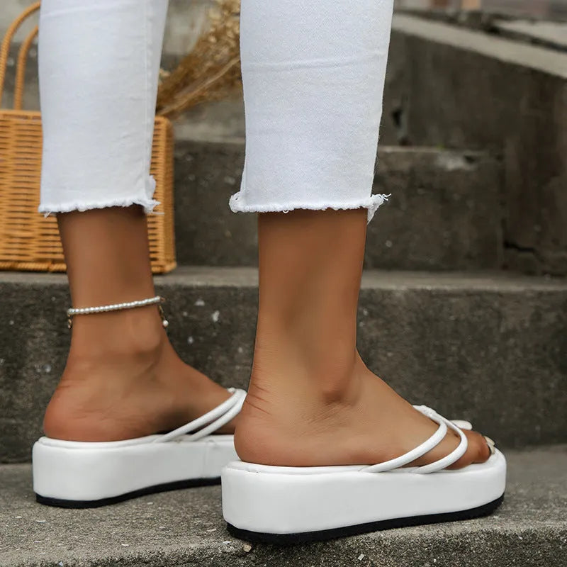 A pair of thick-soled flip-flops in a herringbone strap design, shown in one of six available colours.
