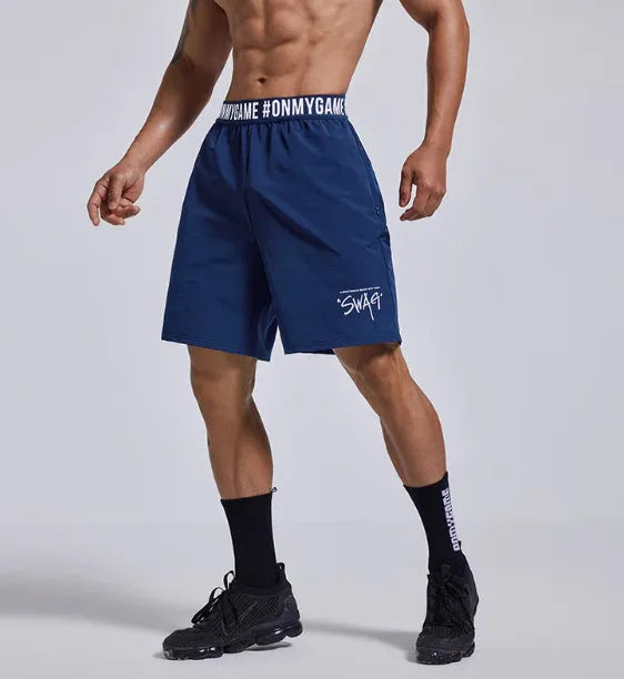 Man wearing loose grey sports shorts with an elastic waistband during a workout.