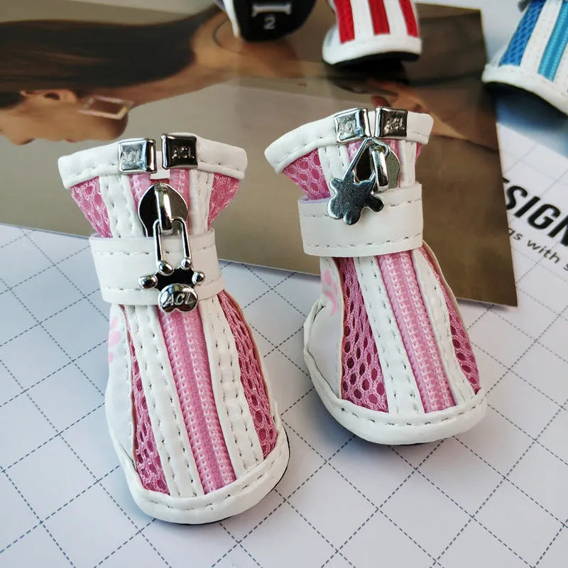 Set of four blue cloth dog shoes with zipper closures and non-slip soles for small pets.