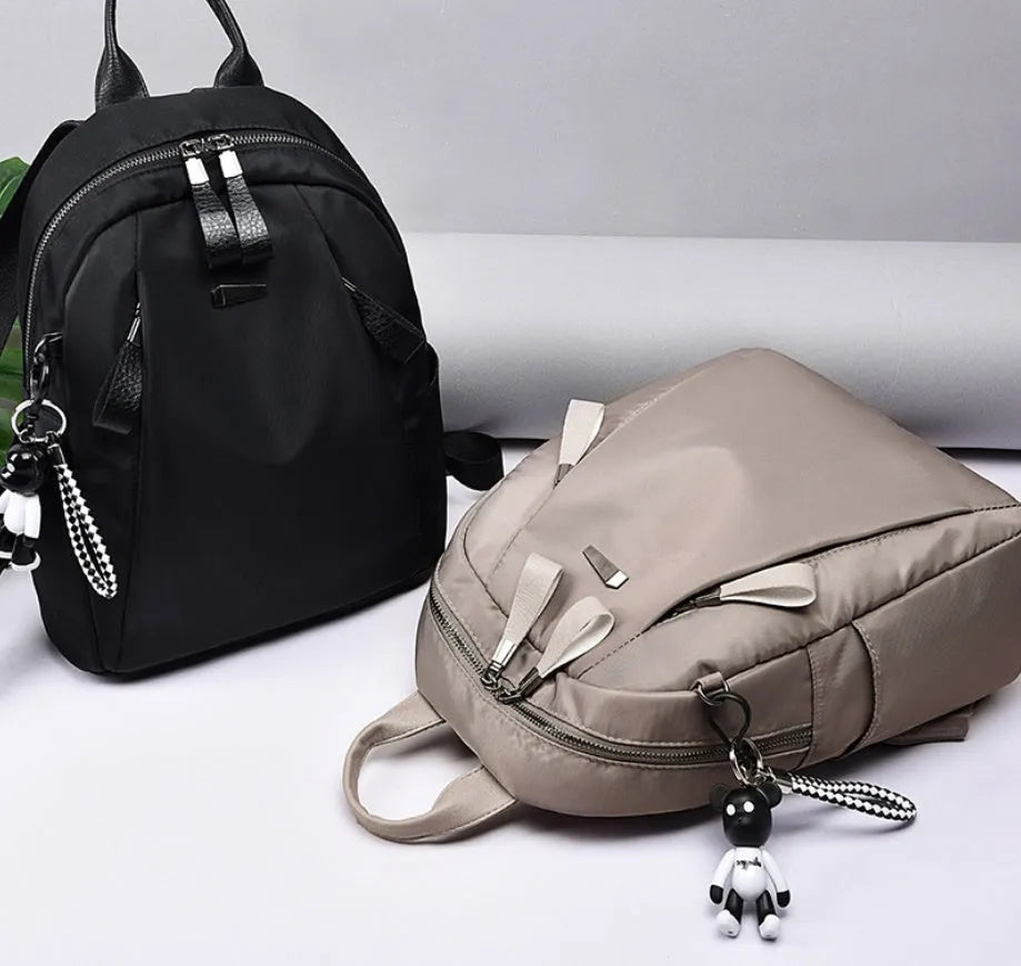 Medium capacity Oxford cloth rucksack in wine red with double straps and organised internal compartments