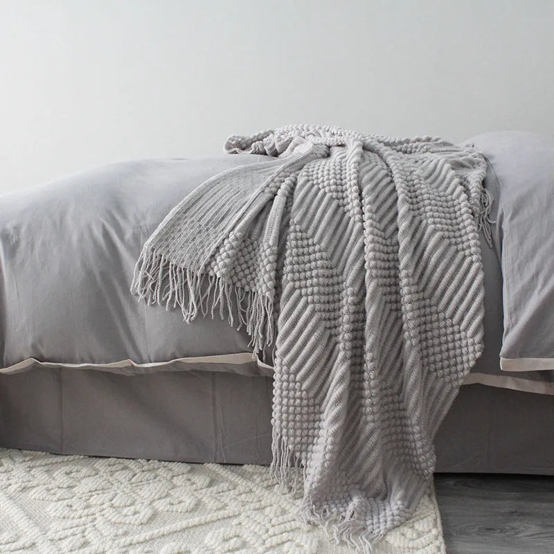 Light grey polyester nap blanket measuring 127cm by 170cm laid flat.