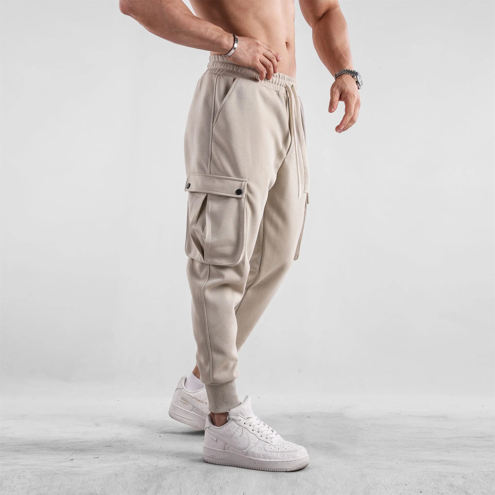 Men's loose fit multi-pocket cotton trousers with ankle ties in apricot colour