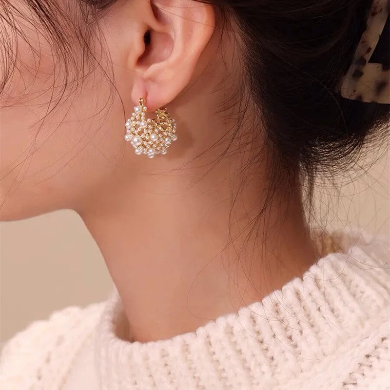 Gold-coloured copper wire flower basket earrings with small beads and inlaid pearls