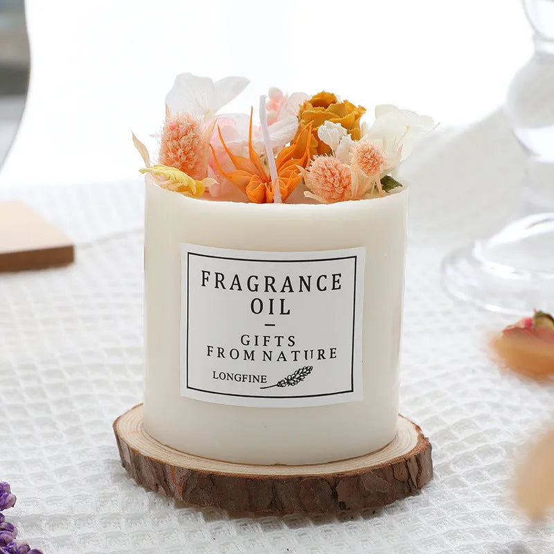 Aromatherapy candle with dried flowers embedded in wax, shown with optional wooden chip base and gift box.