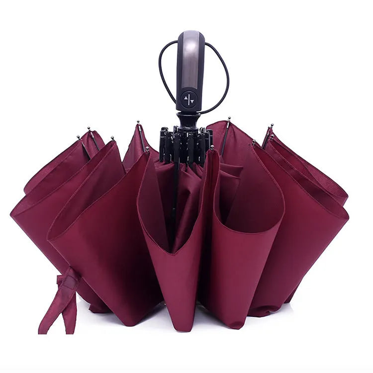 Automatic triple folding black business sun shade umbrella with steel ribs and a rubber handle.