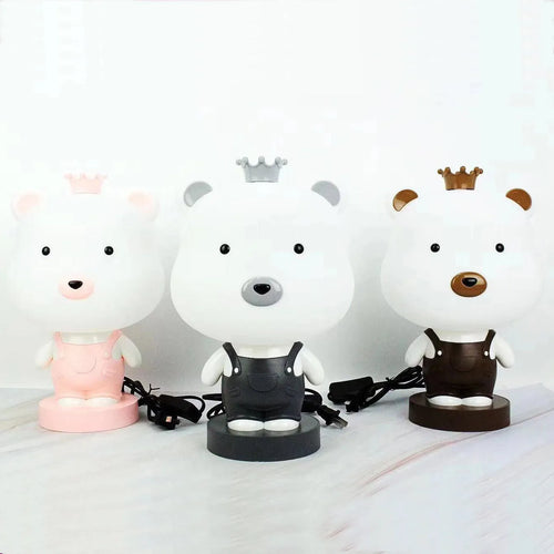 Cartoon animal table lamp in bear, cow, rabbit, or tiger design with plastic shade and LED light.