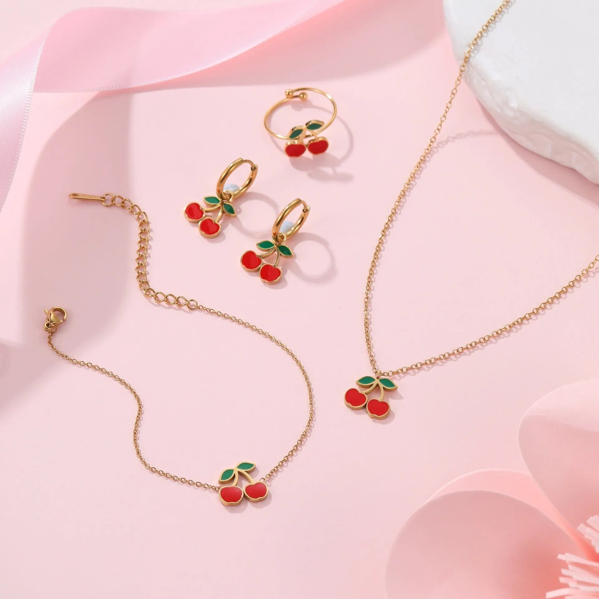 Four-piece cherry jewellery set with necklace, bracelet, earrings and ring in stainless steel with gold-toned finish