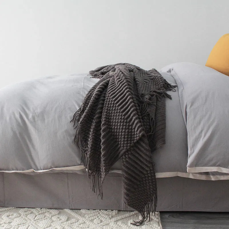 Light grey polyester nap blanket measuring 127cm by 170cm laid flat.
