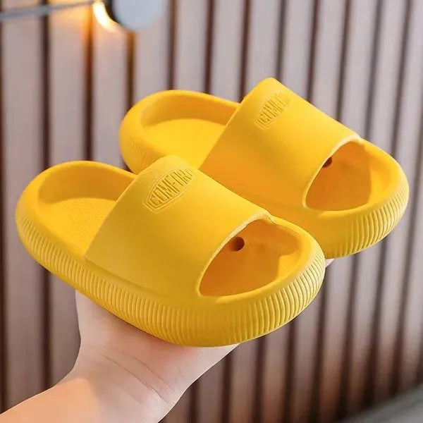 Colourful children's EVA slippers with a thick, textured non-slip sole in various sizes.