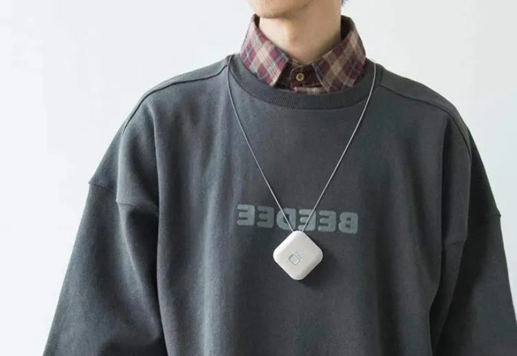 Mini USB portable air purifier necklace in blue, shown next to its charging cable.