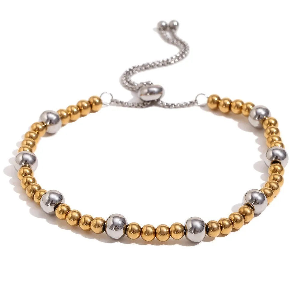 Gold electroplated stainless steel jewellery set comprising geometric earrings, bracelet and necklace.