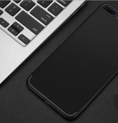 TPU silicone protective case for Apple iPhone on a table, shown in black, blue, red, and white colour options.