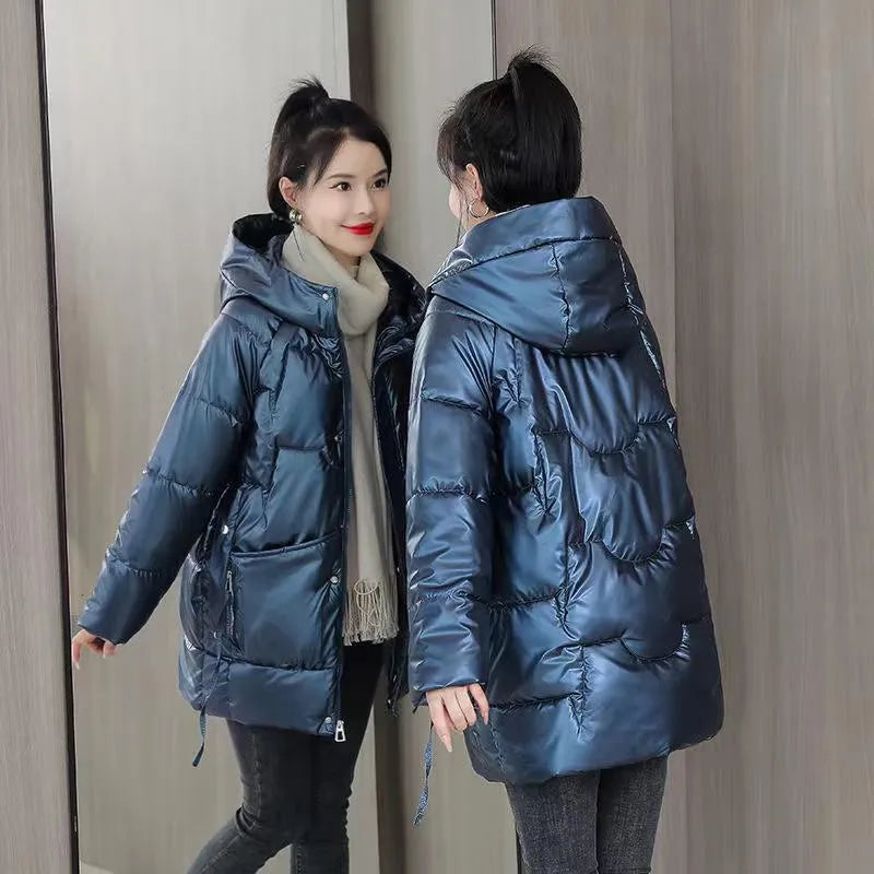 A woman's loose-fitting, thick, hooded winter jacket in a choice of colours on a size chart background.