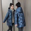 A woman's loose-fitting, thick, hooded winter jacket in a choice of colours on a size chart background.