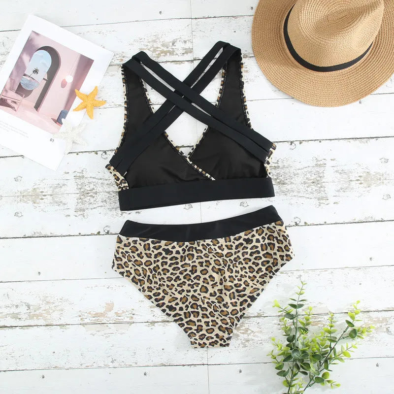 Women's leopard print bikini set with V-neck top and split skirt style briefs.