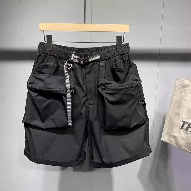 Men's loose fit black work shorts with pockets, shown on a model