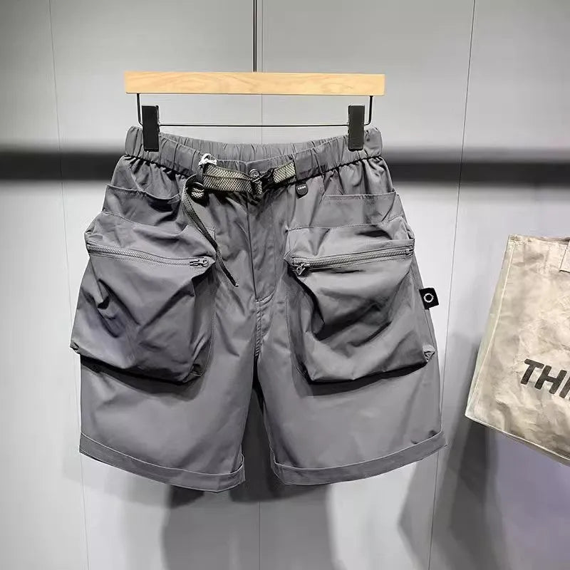 Men's loose fit black work shorts with pockets, shown on a model
