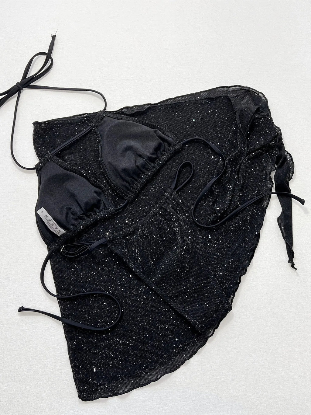 Black three-piece bikini swimsuit set with separate top and shorts on mannequin