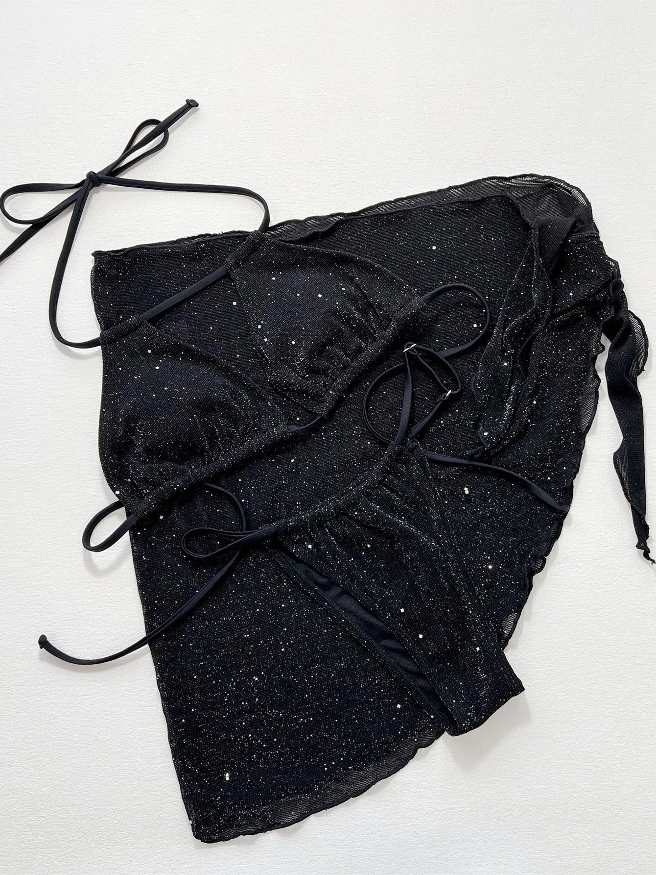 Black three-piece bikini swimsuit set with separate top and shorts on mannequin