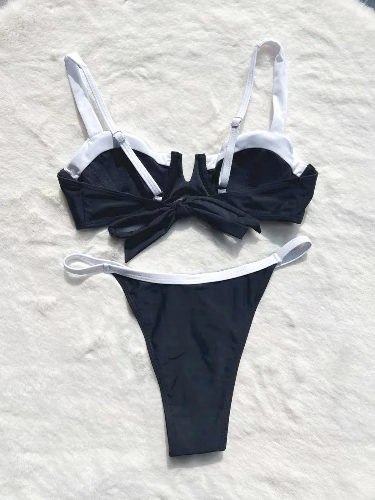 Black low waist women's bikini swimsuit with stitching split detail and briefs style.