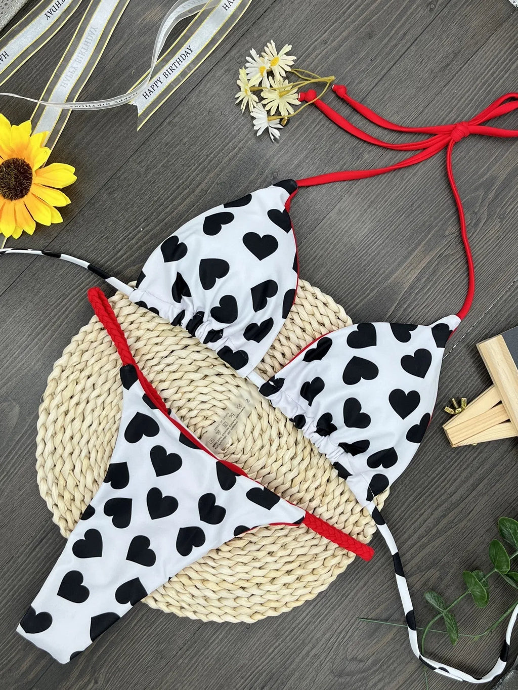 Backless one-piece swimsuit with heart print and split design in quick-dry nylon fabric.