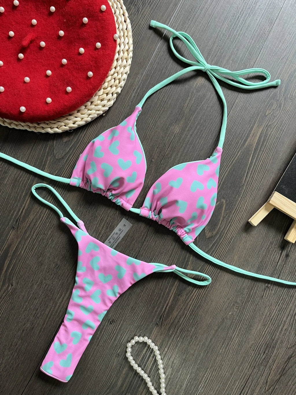 Backless one-piece swimsuit with heart print and split design in quick-dry nylon fabric.