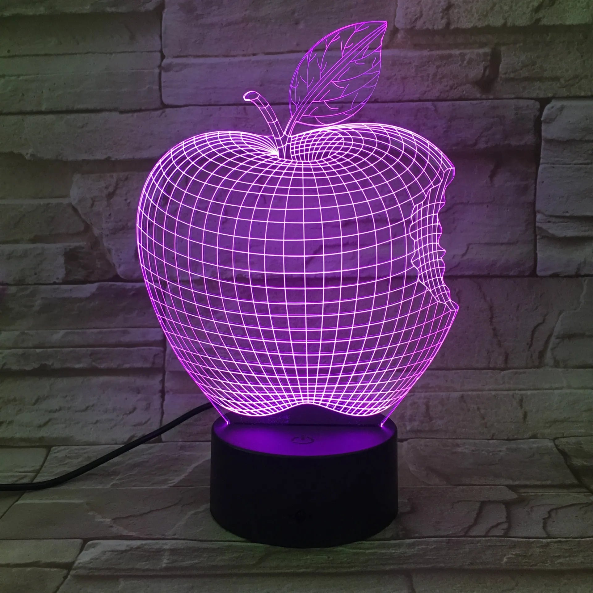Colourful 3D fruit-shaped LED night light with touch control on a surface.