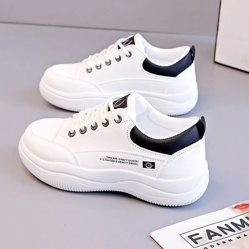 Women's white Korean-style casual shoes with cross strap detail and a synthetic leather upper.