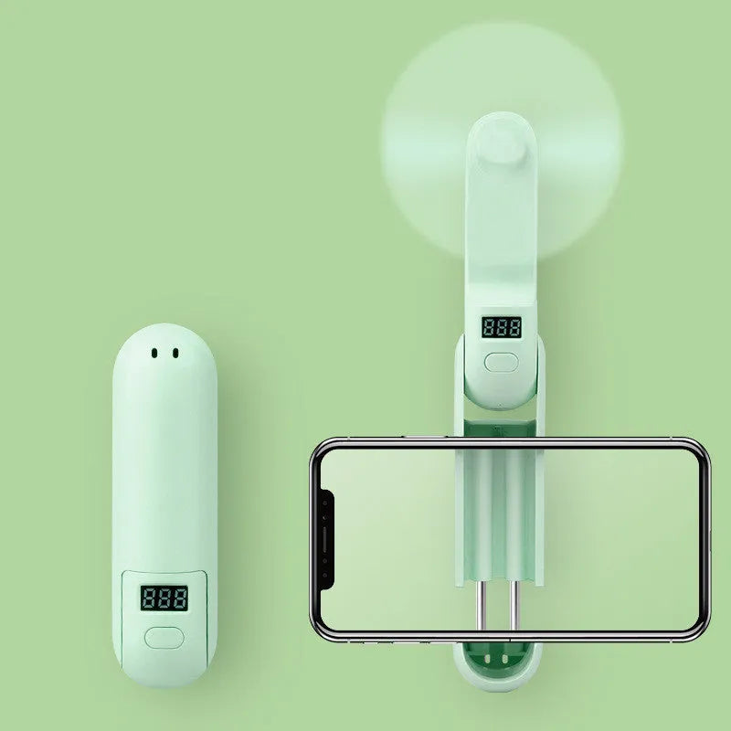 Green folding portable USB rechargeable mini fan with plastic leaves, shown open and closed.