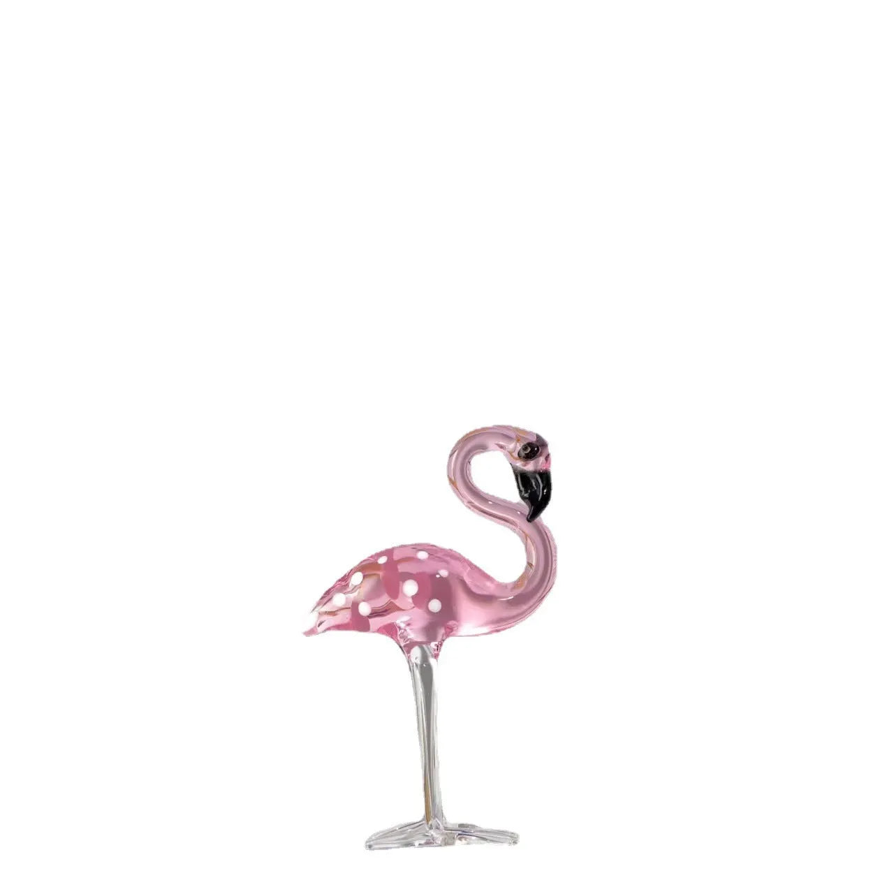 Clear crystal flamingo decorative sculpture with pink dots on a table.