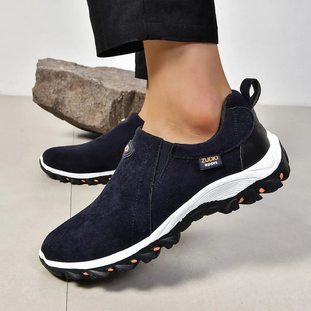 Men's thin grey overshoe cover with round toe and rubber sole, shown on a shoe.