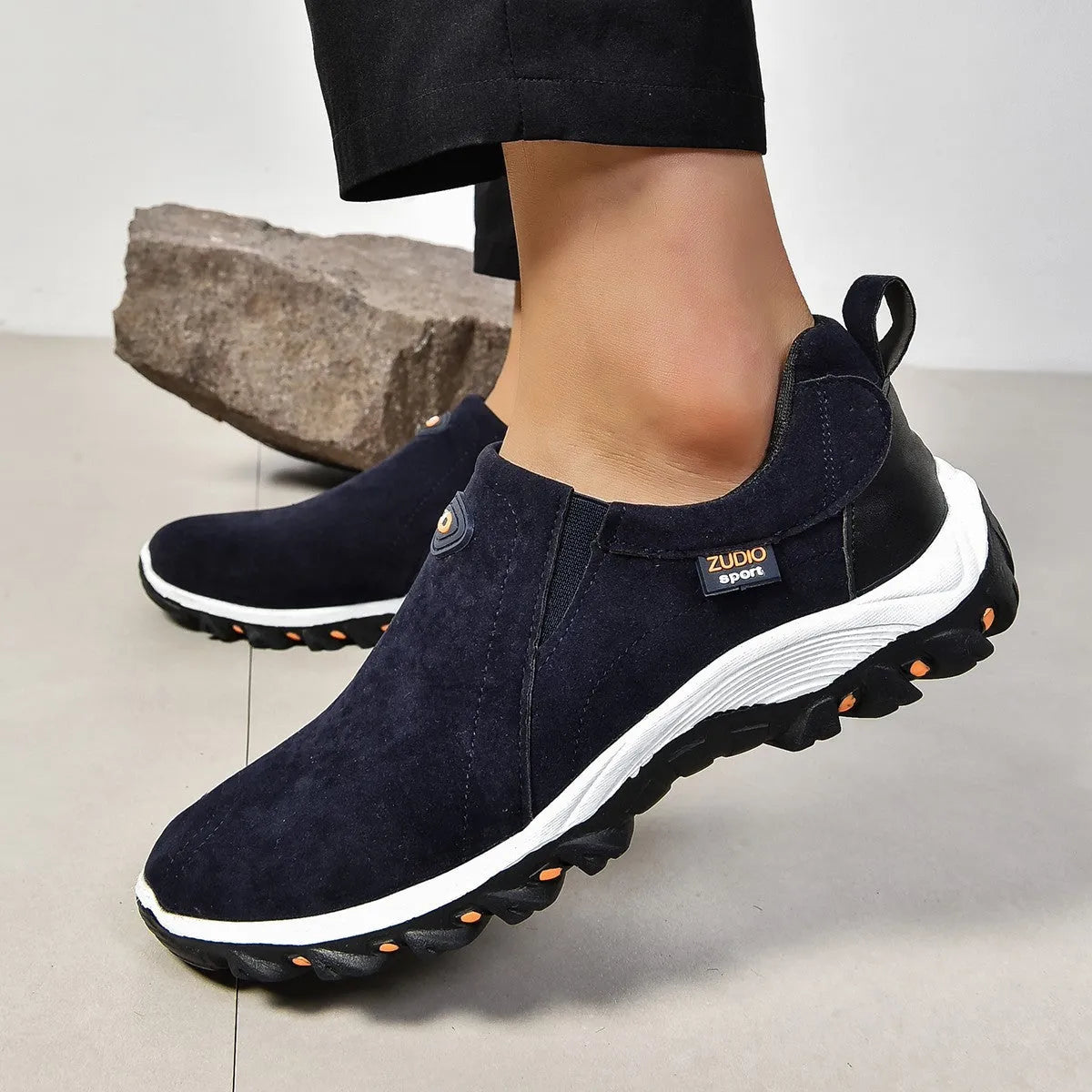 Men's thin grey overshoe cover with round toe and rubber sole, shown on a shoe.