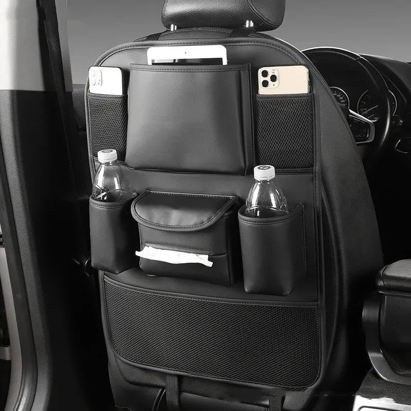 A leather car seat back storage bag hanging behind a vehicle seat.