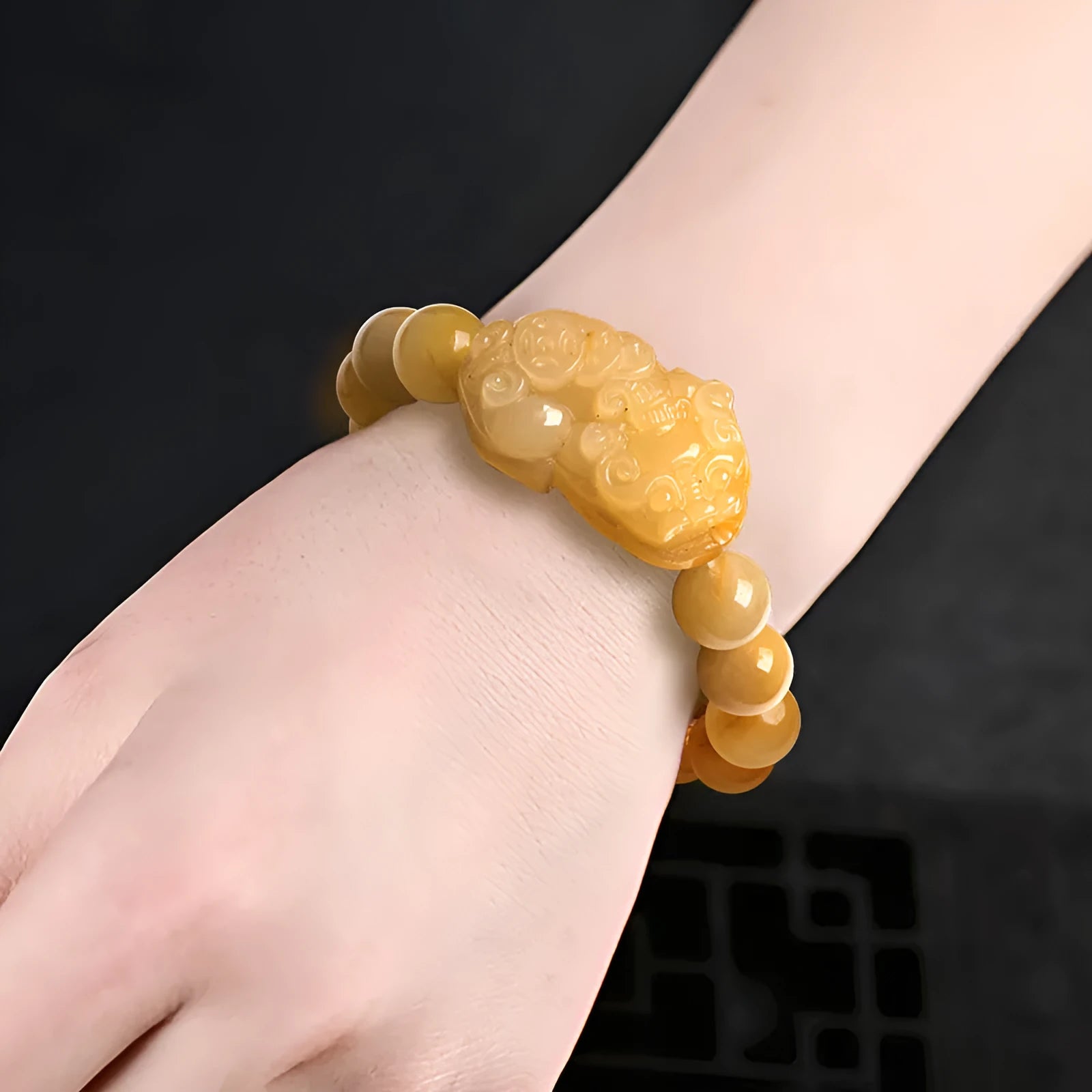 Golden Thread Jinsi Jade money bracelet with carved beads in two size options.