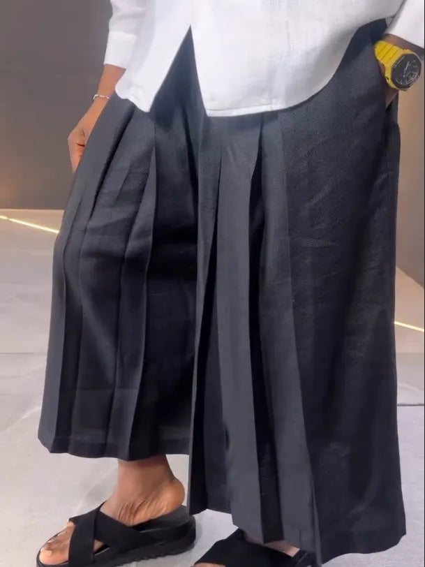 Women's white asymmetric hem shirt and black pleated trousers co-ord set in polyester