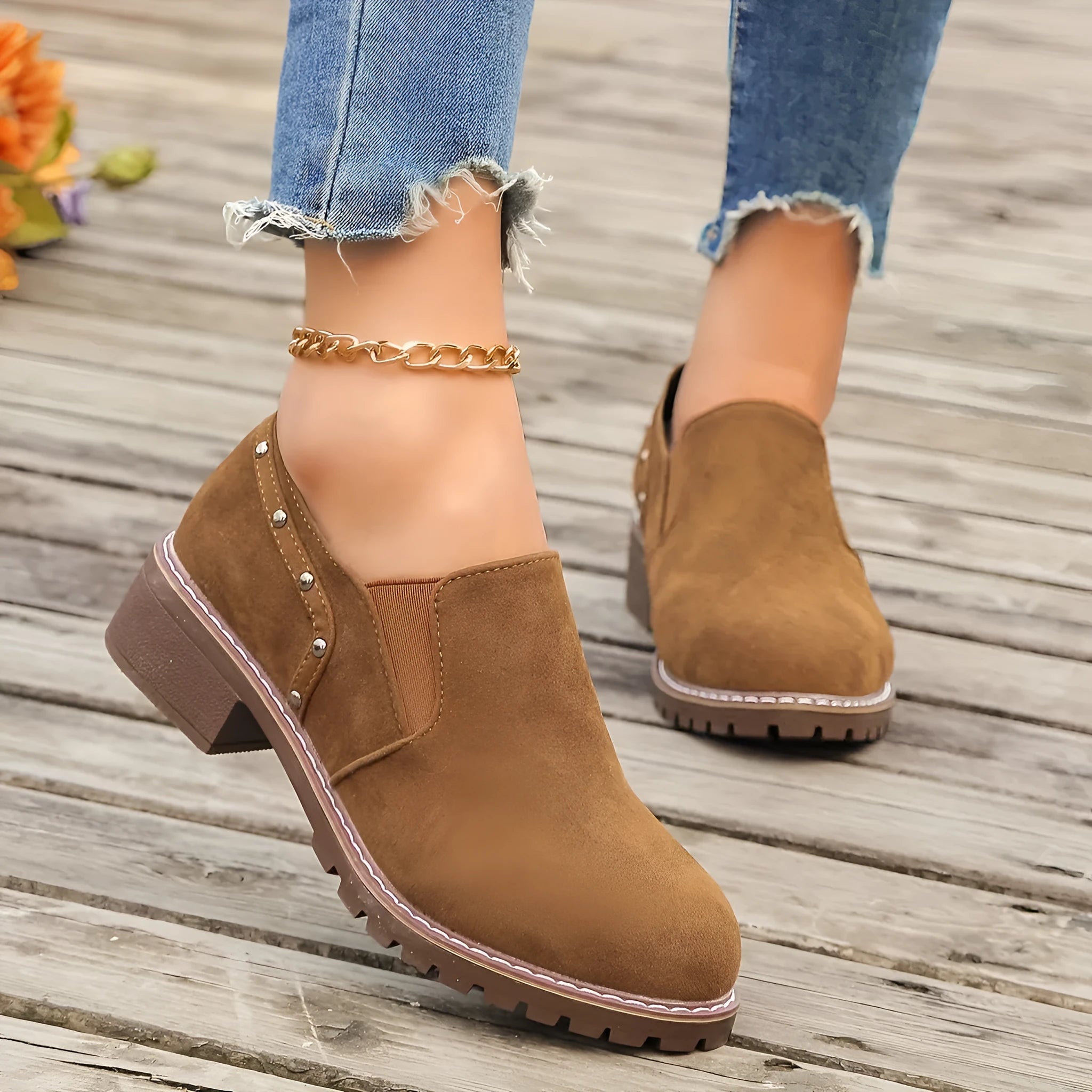 Light brown suede women's ankle boots with low heel and elastic band on a white background.