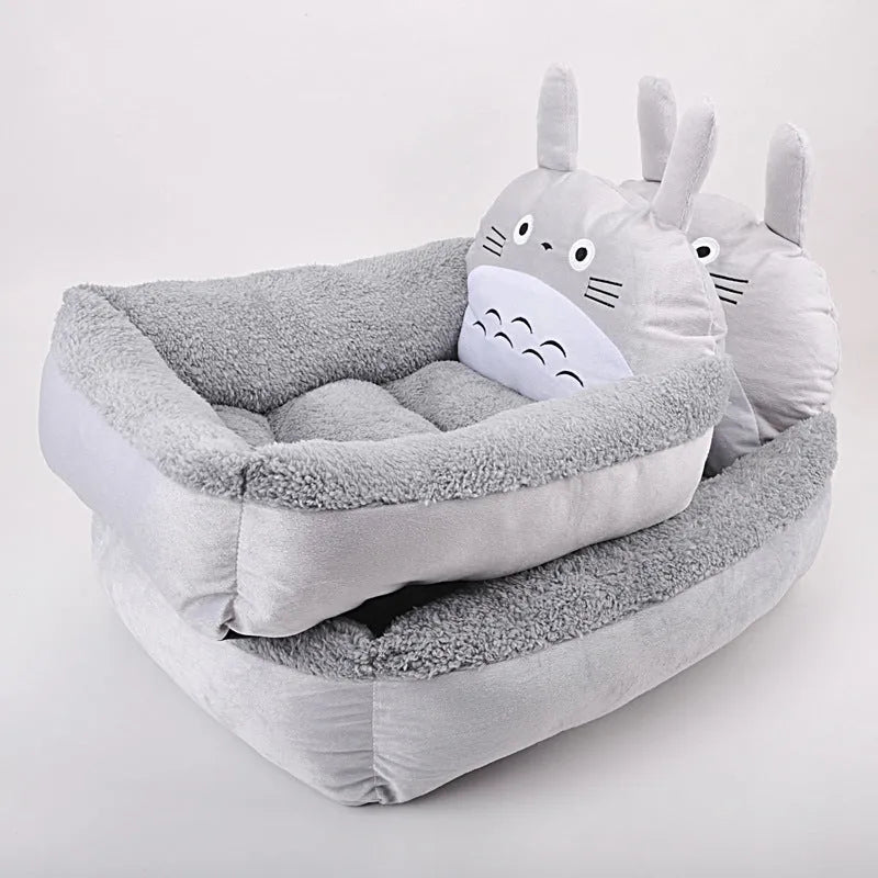 A colourful cartoon-style sofa bed for small pets, shown in blue, with raised edges for comfort.